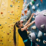 women rock climbing indoorsg