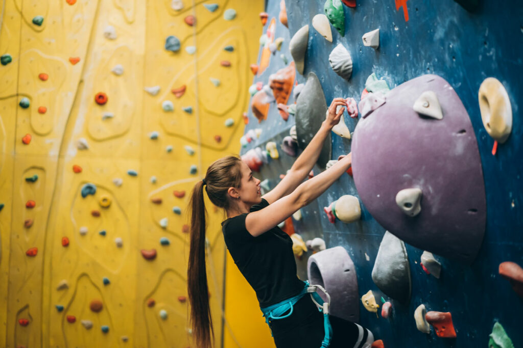 women rock climbing indoorsg