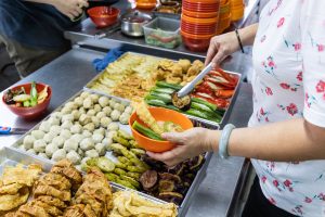 A hawker whipping up a bowl of yong-tau-foo, an ideal candidate for the Hawkers Productivity Grant
