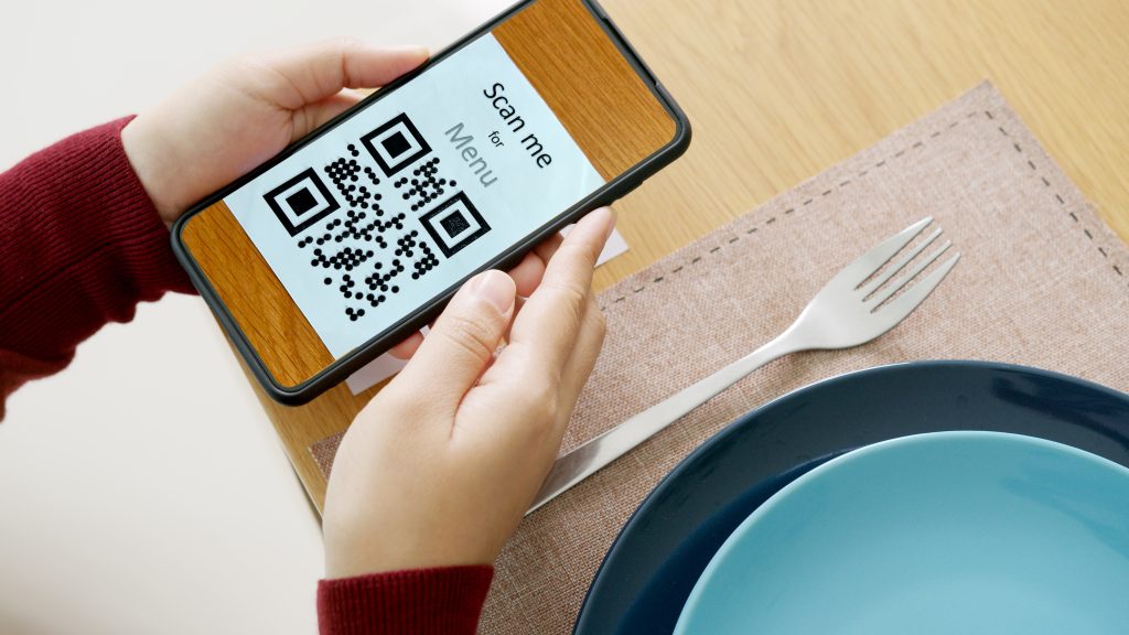 a person performing QR ordering to view an F&B establishment’s menu