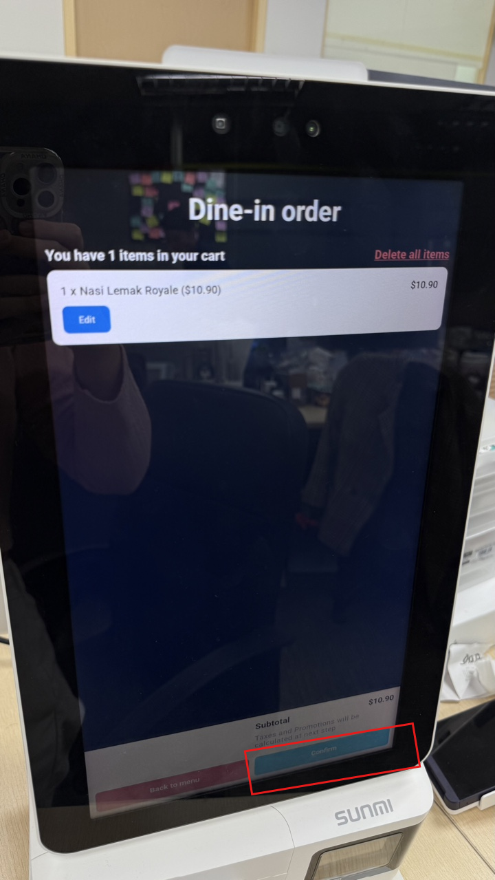 Confirm button on the kiosk
